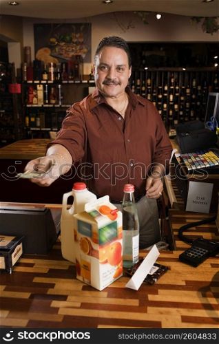 Small business owner ringing up groceries
