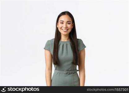 Small business owners, women entrepreneurs concept. Smiling young asian businesswoman starting own startup, looking confident, wearing dress standing over white background.. Small business owners, women entrepreneurs concept. Smiling young asian businesswoman starting own startup, looking confident, wearing dress standing over white background