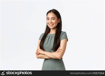Small business owners, women entrepreneurs concept. Successful confident asian businesswoman in dress, cross arms and looking pleased at camera, smiling, managing store or internet site.. Small business owners, women entrepreneurs concept. Successful confident asian businesswoman in dress, cross arms and looking pleased at camera, smiling, managing store or internet site