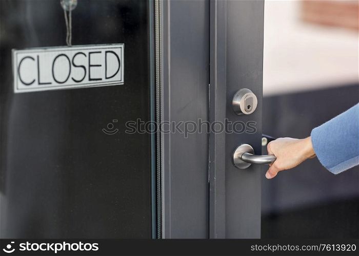 small business, pandemic and service concept - hand trying to open closed office door. hand trying to open closed office door