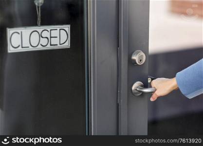 small business, pandemic and service concept - hand trying to open closed office door. hand trying to open closed office door