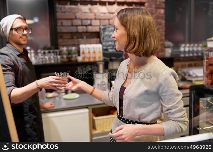 small business, people and service concept - happy bartenders at cafe or coffee shop. happy bartenders at cafe or coffee shop
