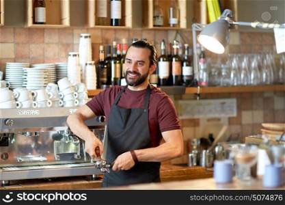 small business, people and service concept - happy man or waiter in apron with holder and tamper preparing espresso at coffee shop. barista with holder and tamper making at coffee