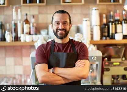 small business, people and service concept - happy man or waiter in apron at bar or coffee shop. happy man, barman or waiter at bar