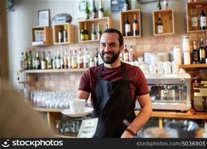 small business, people and service concept - happy man or waiter with coffee cup serving customer giving him money at bar. man or waiter serving customer at coffee shop