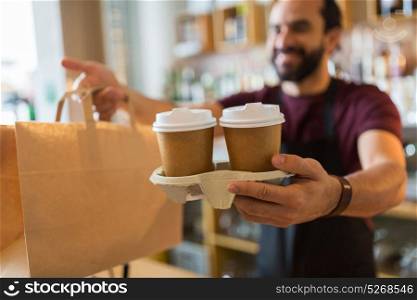 small business, people and service concept - man or bartender serving customer at coffee shop. man or bartender serving customer at coffee shop