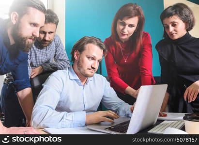 Small business working process. Business team working laptop in modern loft office at sunset