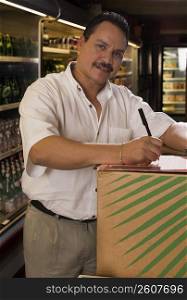Small businessman taking inventory of grocery items