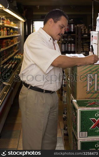 Small businessman taking inventory of grocery items