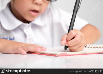 Small businesswoman taking notes while working in the office. Children and business concepts