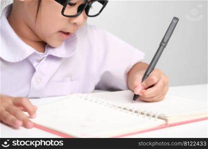 Small businesswoman taking notes while working in the office. Children and business concepts