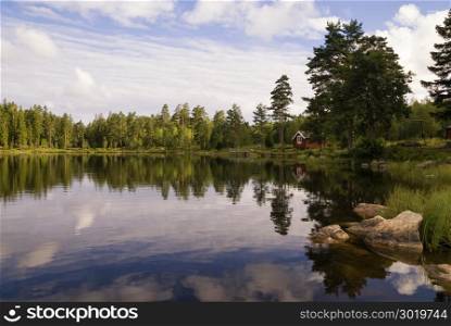 Small cabin on a lake near the Swedish hamlet Annaboda in the surroundings of Orebro. Lake near Annaboda