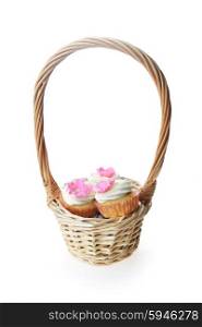 Small cakes with sweet icing in wicker basket