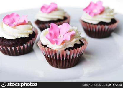 Small cakes with sweet icing on white background