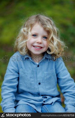 Small child enjoying of a sunny day. Small child with long blond hair enjoying of a sunny day