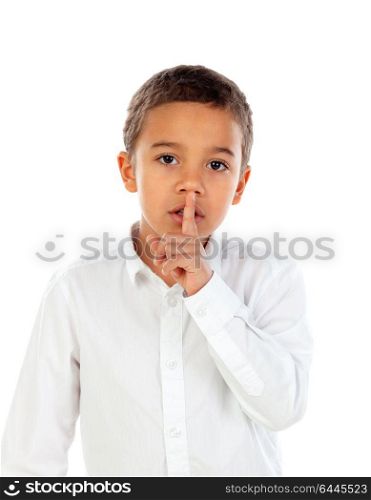 Small child has put forefinger to lips as sign of silence, isolated on a white background
