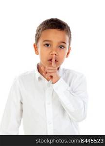 Small child has put forefinger to lips as sign of silence, isolated on a white background