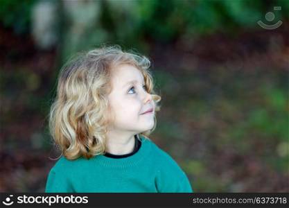 Small child with long blond hair enjoying of a sunny day