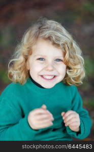 Small child with long blond hair enjoying of a sunny day