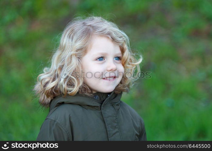 Small child with long blond hair enjoying of a sunny day