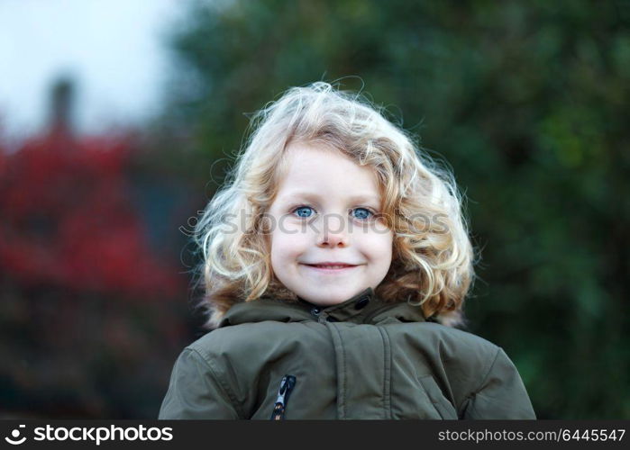 Small child with long blond hair enjoying of a sunny day