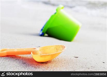 small children bucket and scoop on sea shore