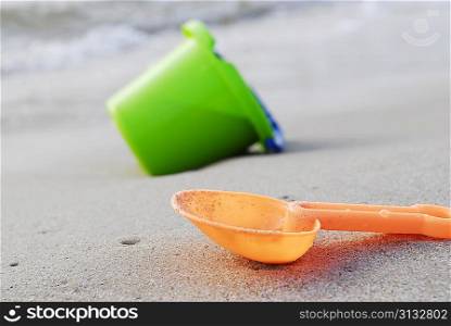small children bucket and scoop on sea shore