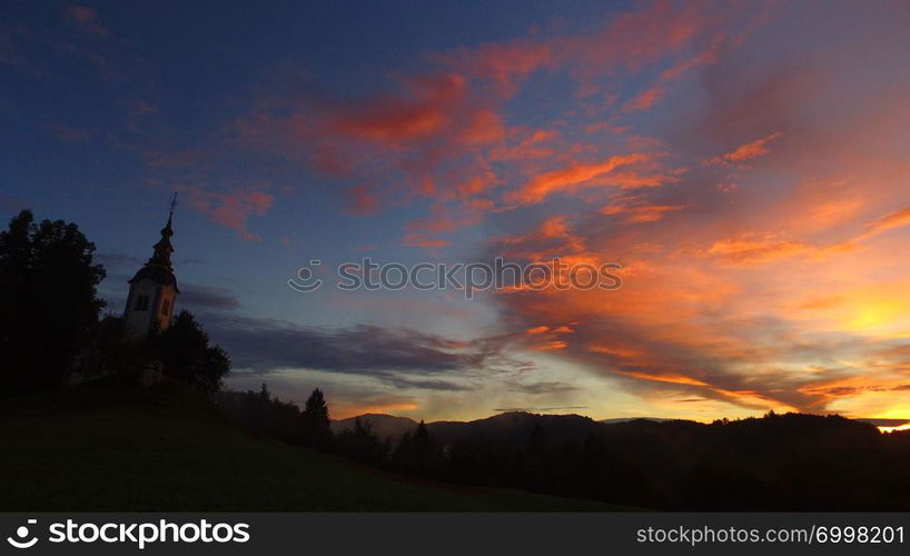 Small church and a sunset in the mountains