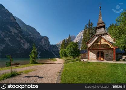 Small church surrounded by nature under the Seekofel mountains next to Lake Braies, Italian landscape in South Tyrol