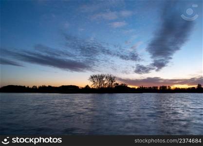 Small clouds after sunset on the lake, Stankow, Poland