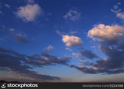 Small Clouds In A Blue Sky At Dusk