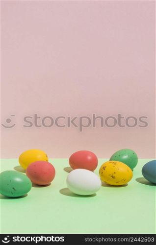 small colorful easter eggs scattered bright table