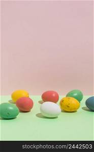 small colorful easter eggs scattered bright table