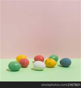 small colorful easter eggs scattered table