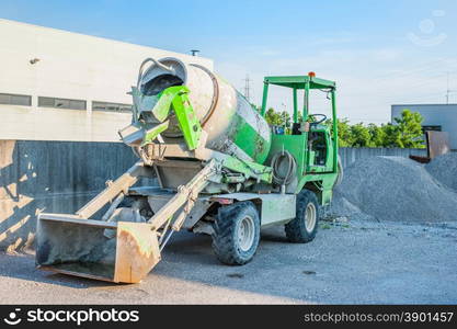 Small concrete mixer truck at the construction site