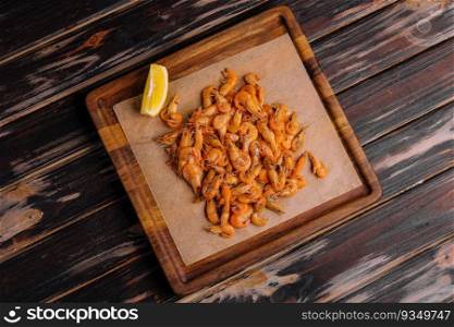 Small cooked shrimp on wooden tray