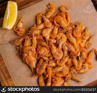 Small cooked shrimp on wooden tray