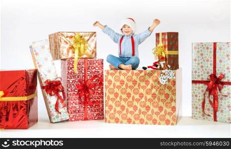 Small cute kid sitting on the gift