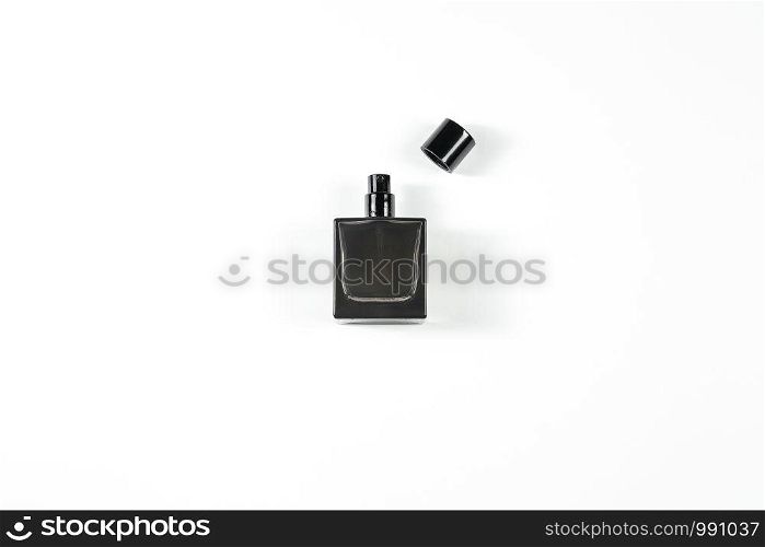 small dark perfume bottle on white isolated background