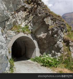 Small dark tunnel in a Swiss mountain