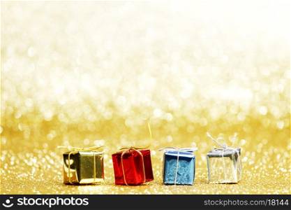Small decorative colorful presents on glitter background