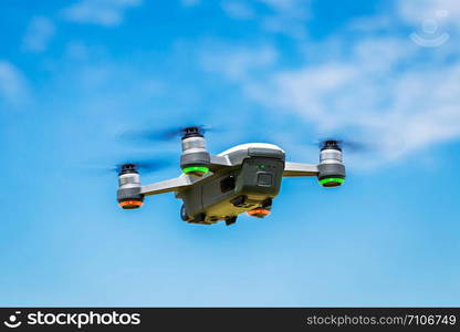 Small drones are flying in the sky.