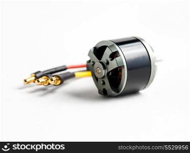 Small electric motor and wires on white background
