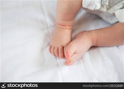 Small feet of a newborn baby on the bed, top view. The concept of motherhood, breastfeeding. Small feet of a newborn baby on the bed, top view. The concept of motherhood, breastfeeding.