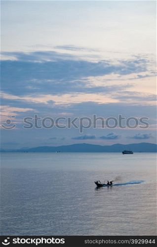 Small ferry Sailing in the sea near the coast in the morning.