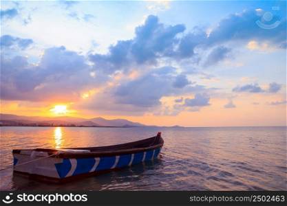 Small fishermans boat at sunset