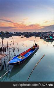small fishing boat at fisherman village with sunset