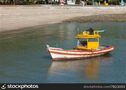 Small fishing boat. Moored in the sea beach is a small fish.