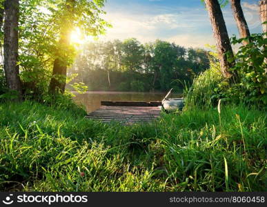 Small fishing pier on a river at sunrise