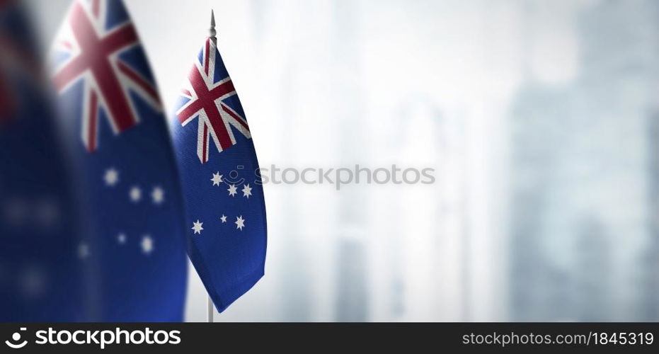 Small flags of Australia on a blurry background of the city.. Small flags of Australia on a blurry background of the city